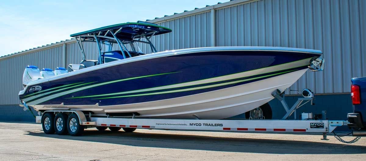 High-performance boat loaded on an enclosed-style transport trailer